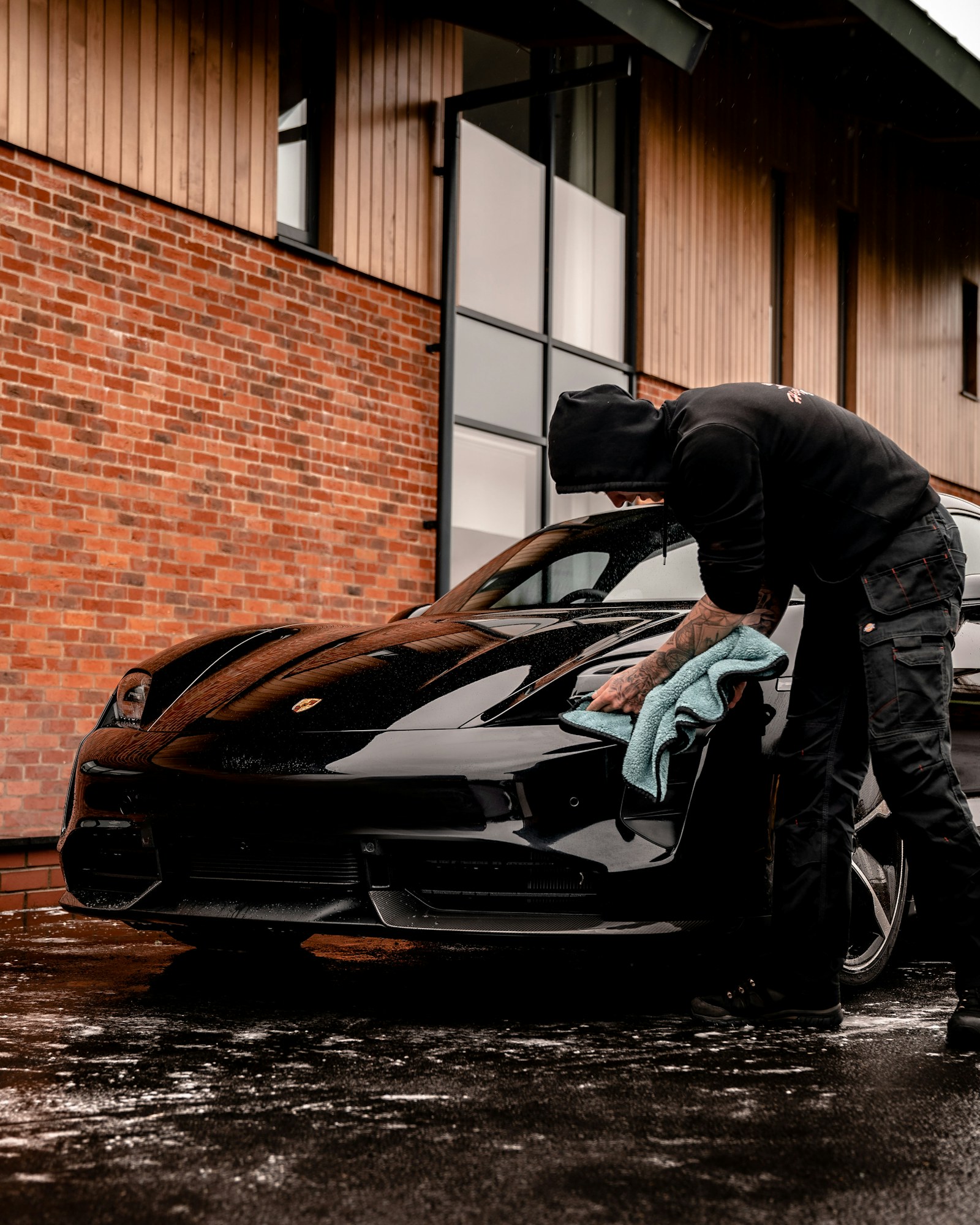 Technician wiping a car body with microfiber